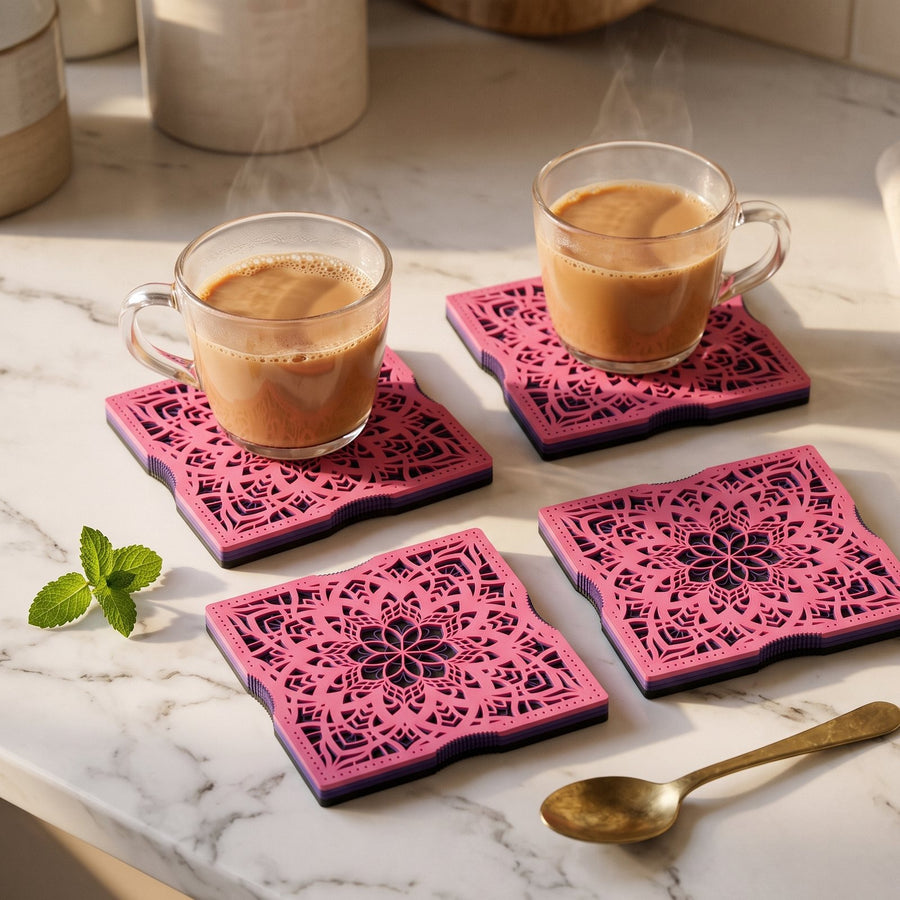 Sakura at Dusk layered mandala coasters on a marble counter with chai