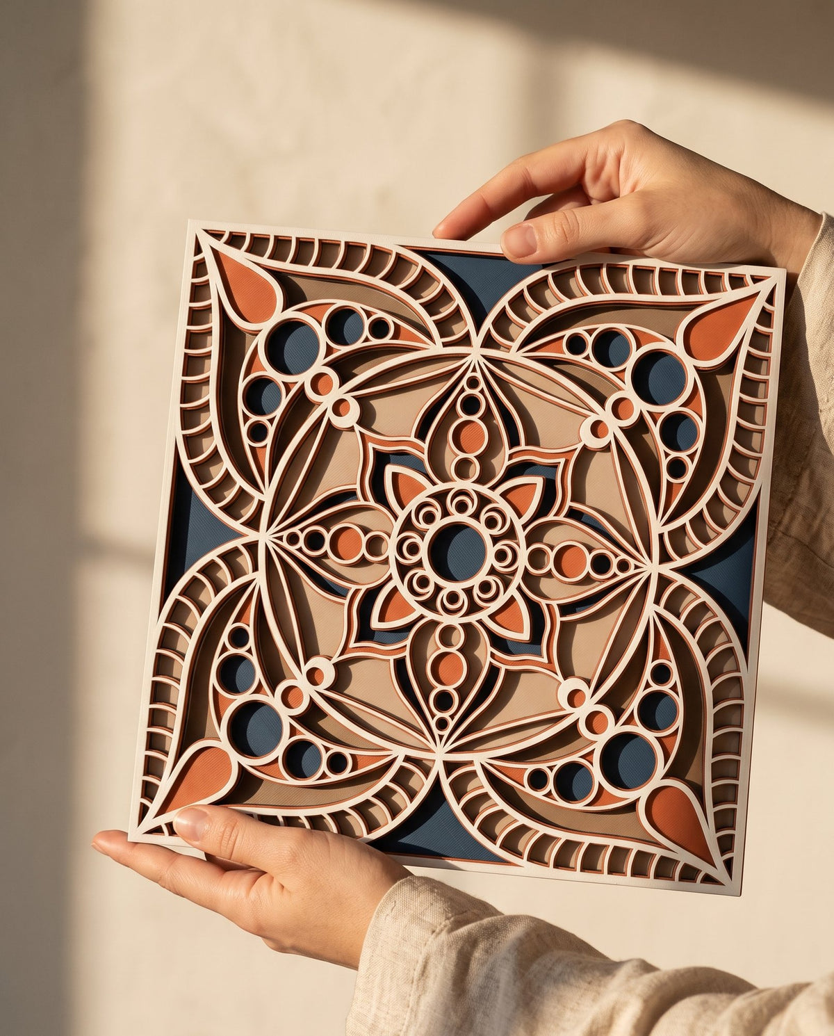 Hands holding the Jaipur Block Print mandala in raking light