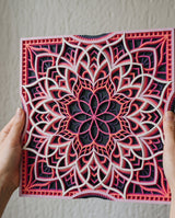 Sakura at Dusk layered mandala held in hand, raking light