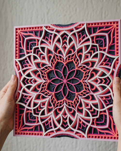 Sakura at Dusk layered mandala held in hand, raking light